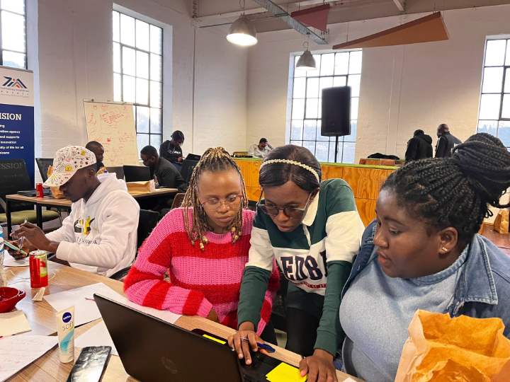Participants working together on a laptop