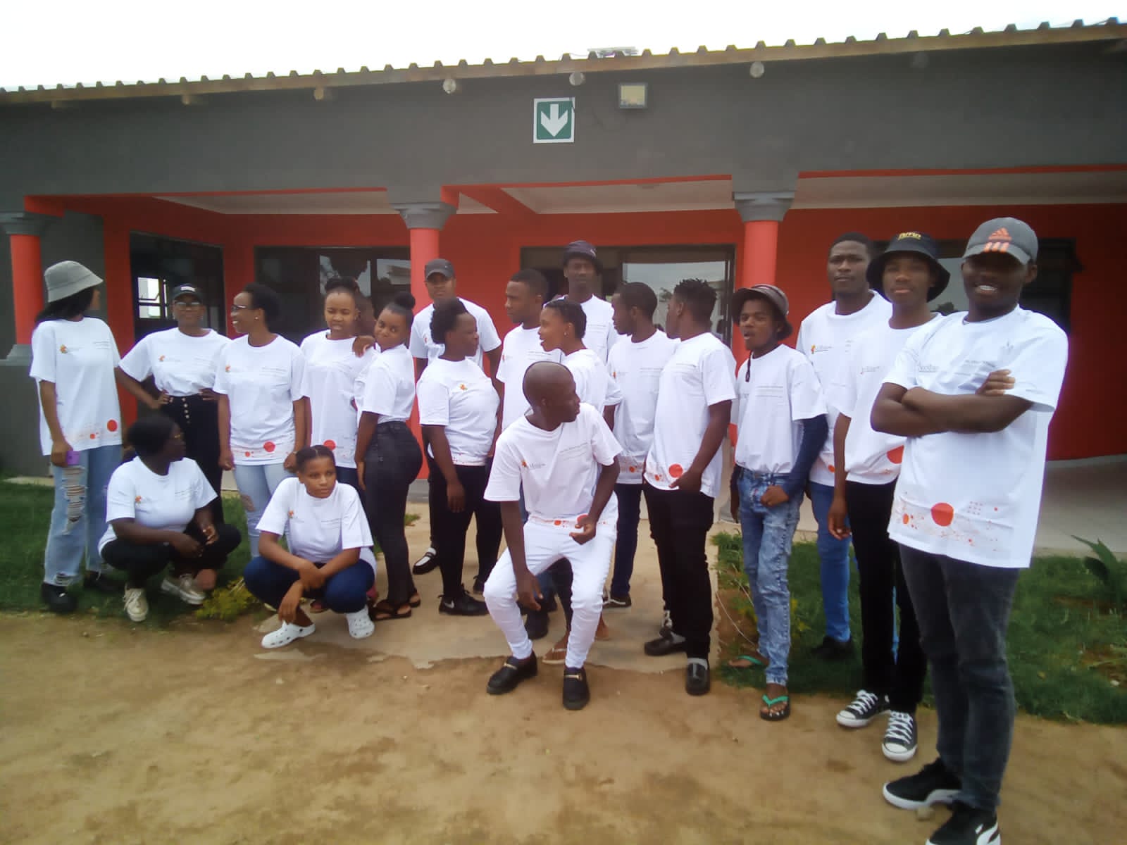 Group of participants in matching white t-shirts outside the lab