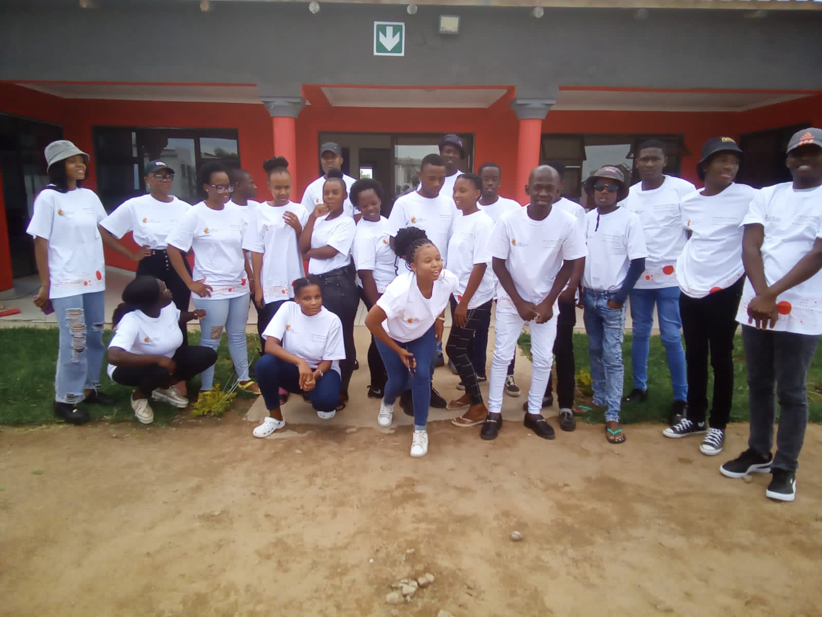 Large group photo of the cohort outside the lab building